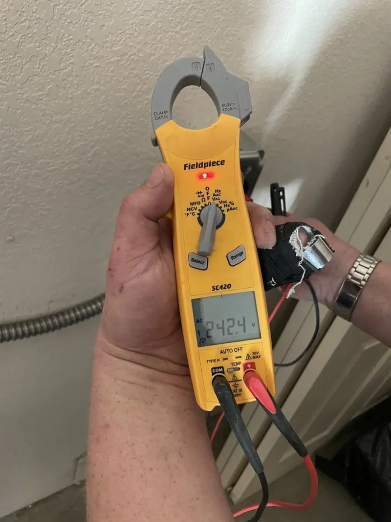 Voltage testing with clamp meter during Recessed Lighting Installation in Eastchester